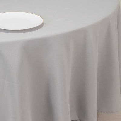 White plate on a gray tablecloth.