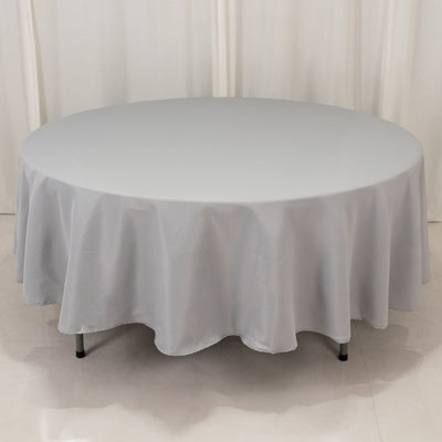Round gray tablecloth on a table, elegantly draped for formal settings.