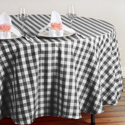 Black and white checkered tablecloth on a round table setting.