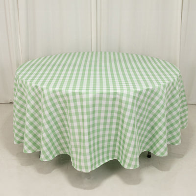 Green and white gingham tablecloth on a round table