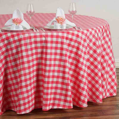 Red and white checkered tablecloth draped over a round table setting.