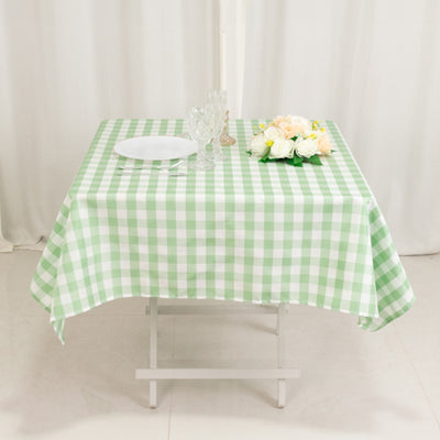 Green and white checkered tablecloth on a dining table with decor.