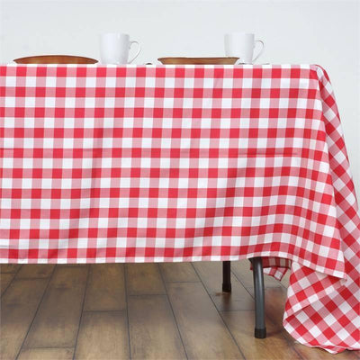 Red and white checkered tablecloth draped over a table with dishes