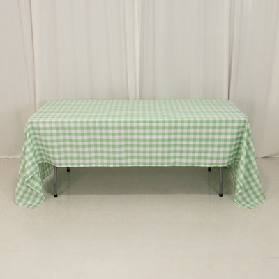 Green and white checkered tablecloth on a table in a studio setting
