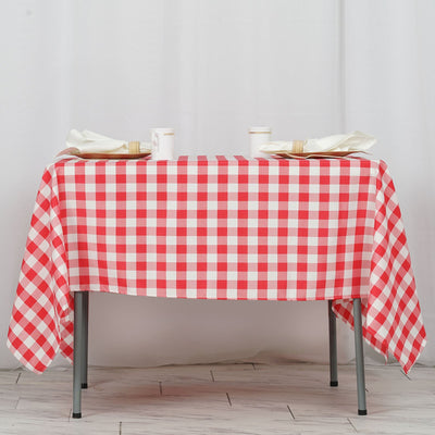 Red and white checkered tablecloth draped over a table with dining setup.