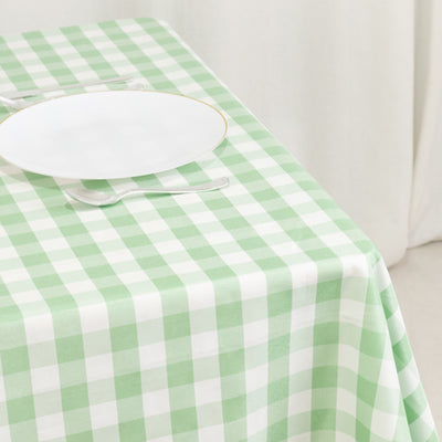 Green and white checkered tablecloth with a white plate and cutlery.