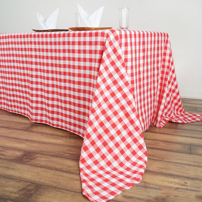 Red and white checkered tablecloth draped over a wooden table.