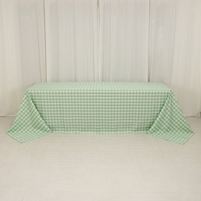 Green and white checkered tablecloth draped on a table.