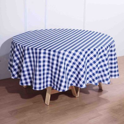 Round blue and white checked tablecloth on a wooden table.