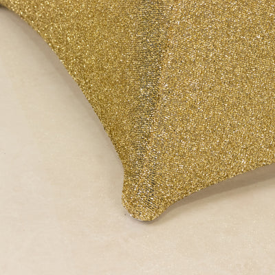 Gold glitter pillow corner on a smooth surface.