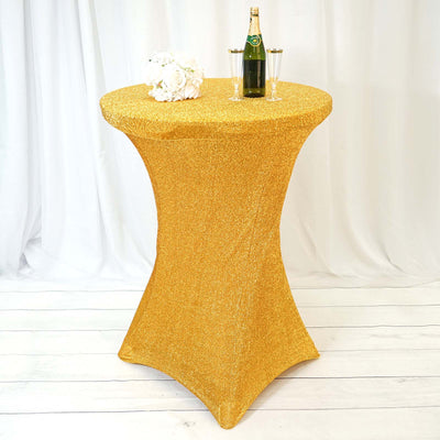 Gold sequin table cover on a high top table with champagne and glasses.