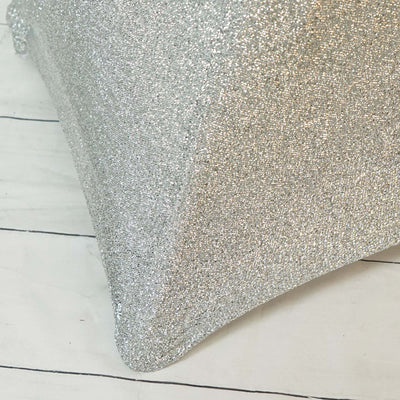 Silver glitter pillow with a soft texture on a white background.