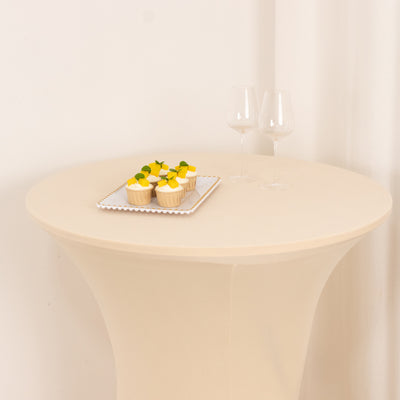 Cupcakes on a tray with two glasses on a round table.
