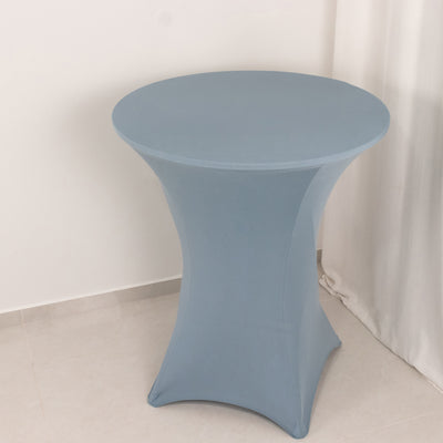 Blue stretch table cover on a round table in a minimalist setting.