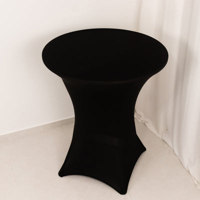 Black cocktail table with a sleek design on a plain backdrop.