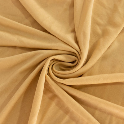 Soft beige fabric swirl texture close-up, ideal for fashion and design.