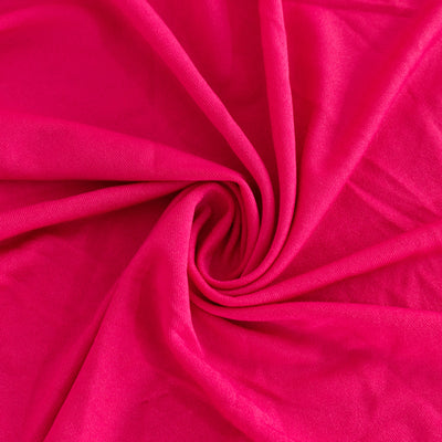 Bright pink fabric in a spiral pattern, showcasing soft texture.