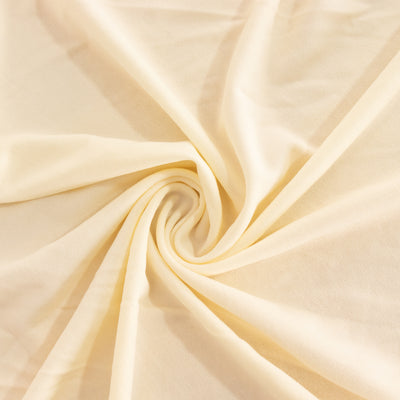 Light cream fabric in a swirling pattern showcasing its soft texture.