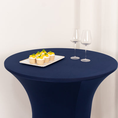 Navy table with cupcakes and two glasses in a simple setting.