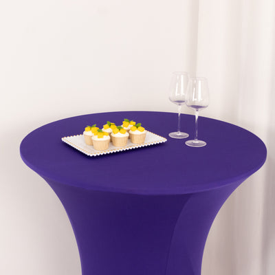 Purple cocktail table with cupcakes and two wine glasses