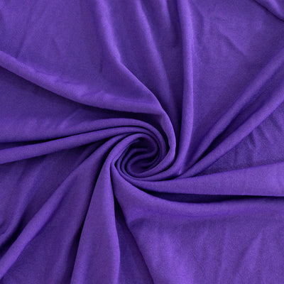 Purple fabric with a smooth texture, arranged in a spiral pattern.