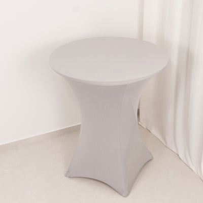 Gray stretch table cover on a round table in a minimalistic setting.