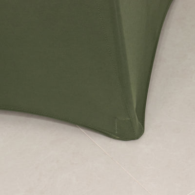 Green fabric corner of a modern furniture piece.