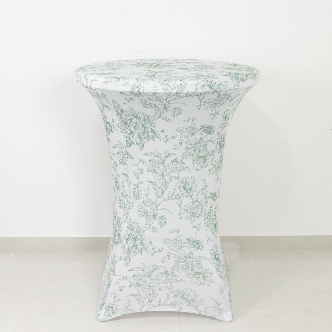 Floral-printed table cover on a round table against a white background