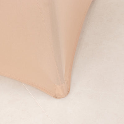 Close-up of a beige fabric corner detail on a smooth surface.