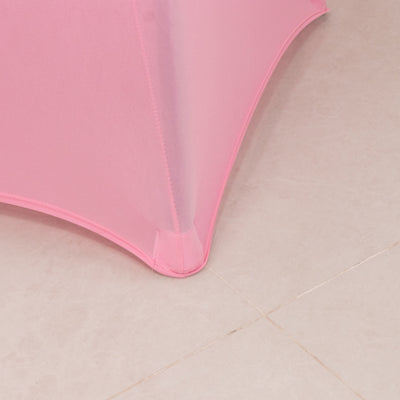 Pink table cover corner detail on a smooth surface.