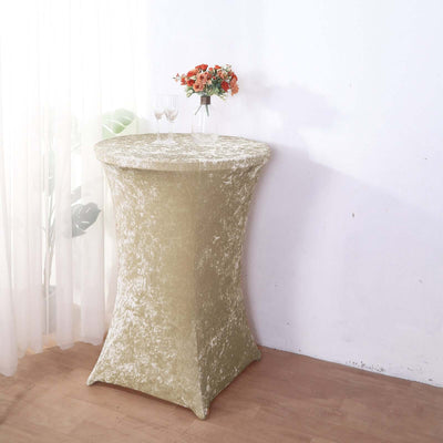 Elegant gold table cover with floral arrangement in a bright setting.