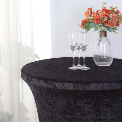 Black velvet table cover with glasses and floral centerpiece.