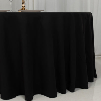 Black tablecloth elegantly draping over a round table.