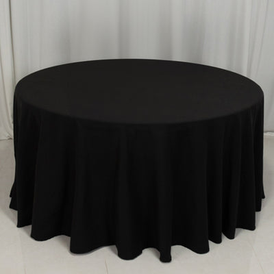 Black round tablecloth with a flowing design.