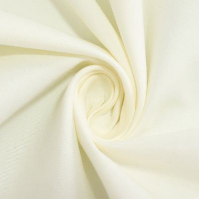 Cream cotton fabric close-up showing texture and softness.