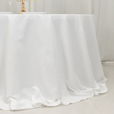 White tablecloth draped elegantly over a round table in a bright setting.
