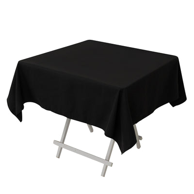 Black tablecloth draped over a folding table.