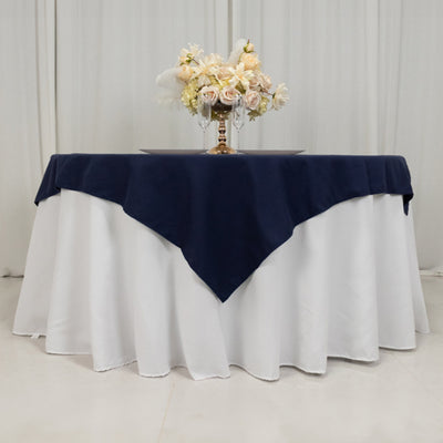 Navy tablecloth draped elegantly over a white table with floral centerpiece.