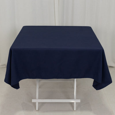 Navy blue tablecloth draped over a white folding table