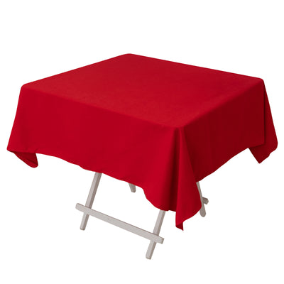Red tablecloth draped over a folding table in a studio-style isolation shot.