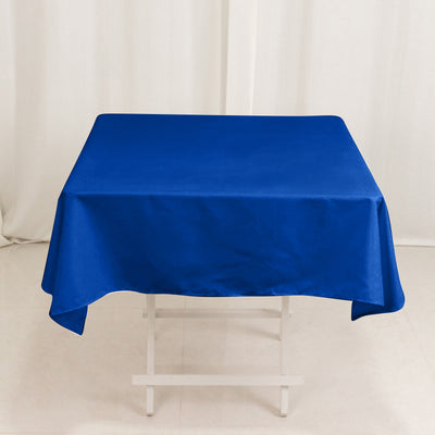 Blue tablecloth draped over a white table.