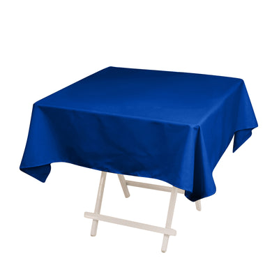 Blue tablecloth on a folding table against a plain background