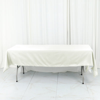 White tablecloth draped over a folding table in a studio setting