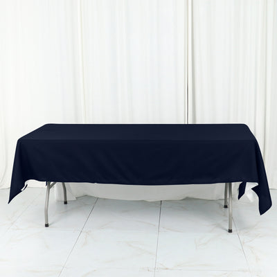 Navy blue tablecloth draped over a folding table against a light background.