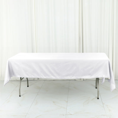 White tablecloth draped over a folding table in a studio setting.
