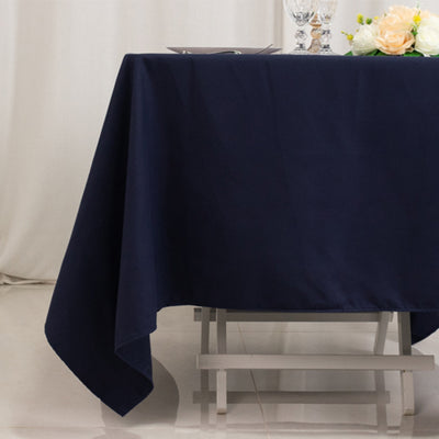 Navy blue tablecloth draped over a table with elegant decor.