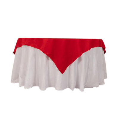 Red tablecloth draped over a white table.