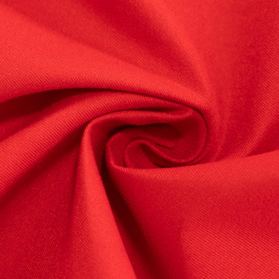 Close-up of soft red fabric showing smooth texture and fold details.
