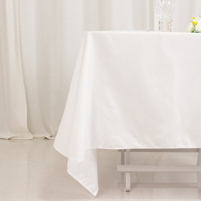 White tablecloth draped on a table in a bright, elegant setting.