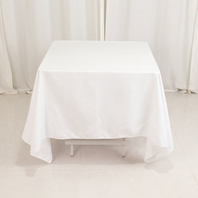 White tablecloth draped over a table in a studio setting.